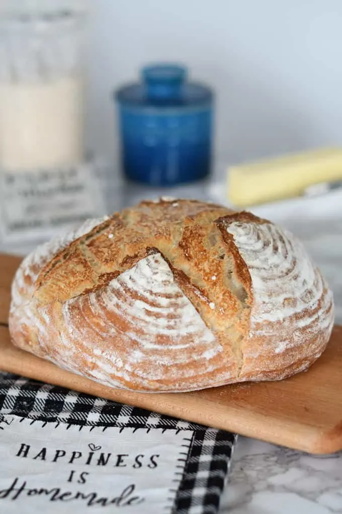 a loaf of artisan sourdough bread on a cutting board