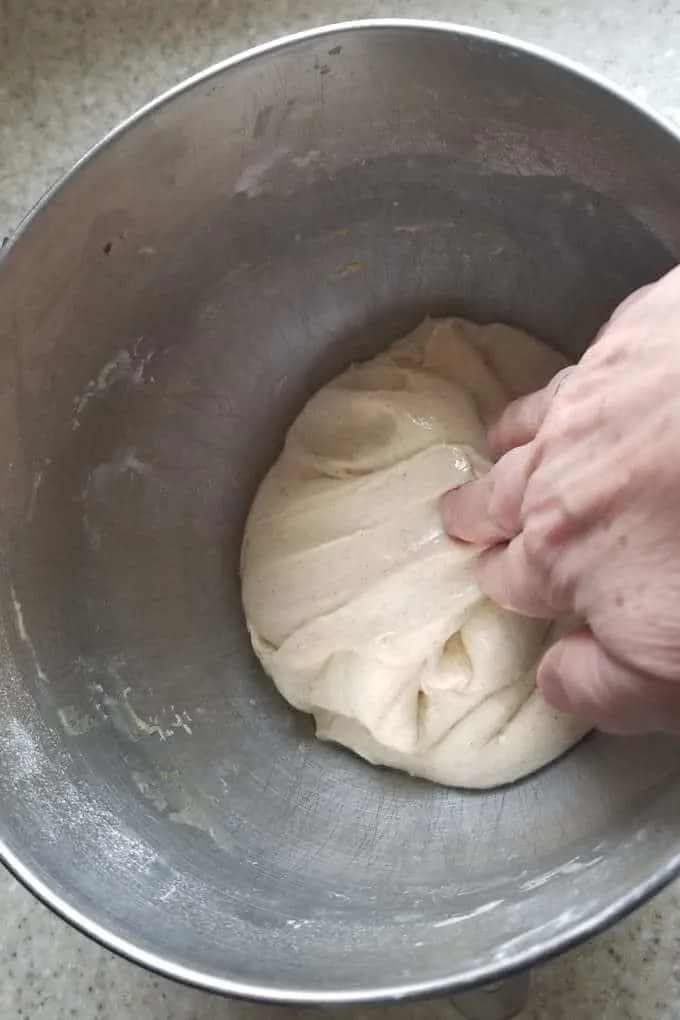 a handing folding sourdough for coffee cake