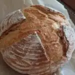 a loaf of sourdough bread on a piece of parchment paper