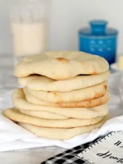 a stack of sourdough pita bread on a table