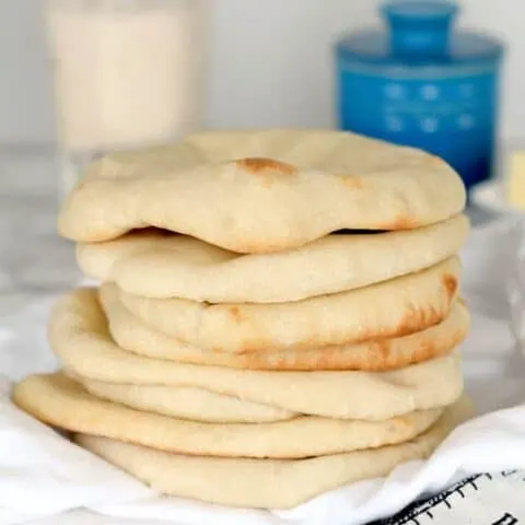 a stack of sourdough pita bread on a table