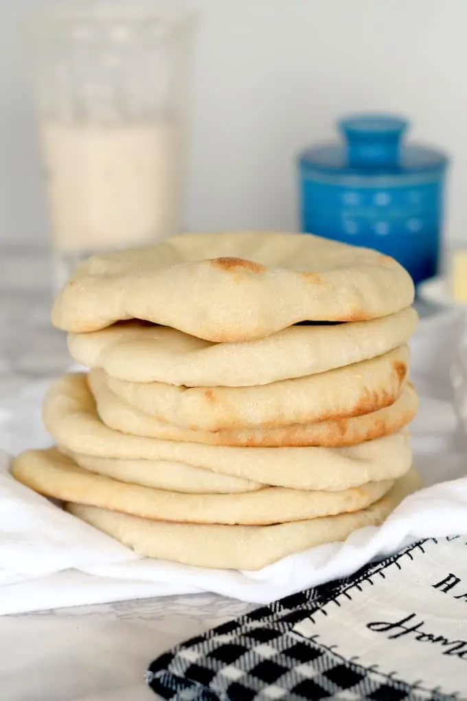 a stack of sourdough pita bread on a table