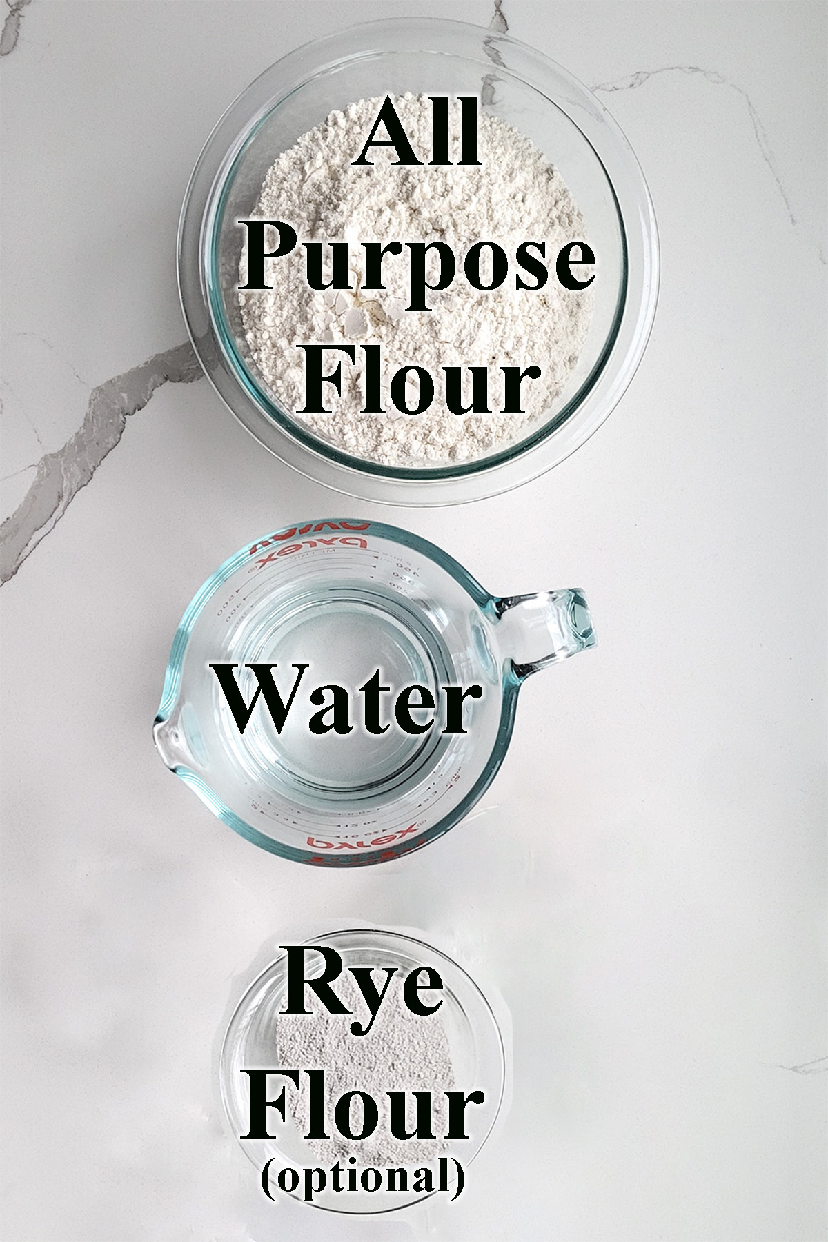 ingredients for making sourdough starter in glass bowls on a white surface.