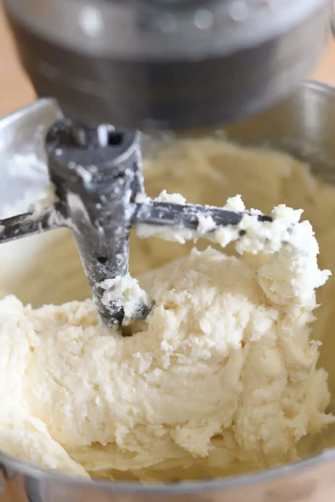 a mixer bowl filled with butter and sugar