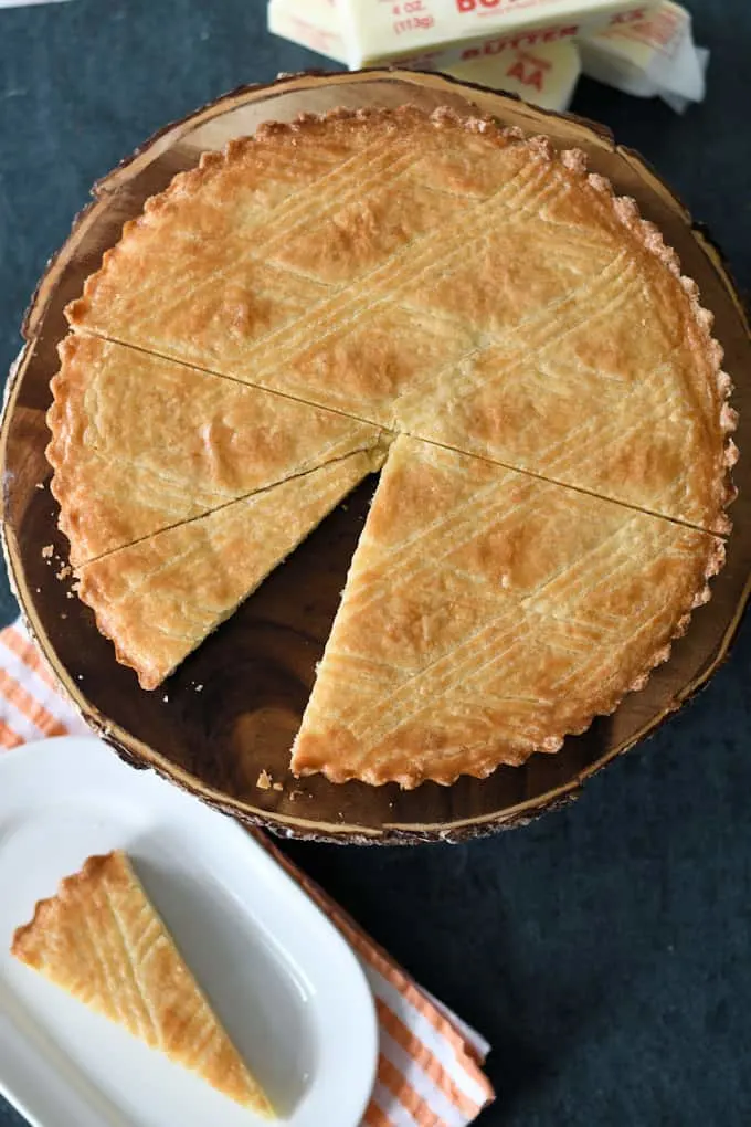 an overhead shot of a dutch boterkoek with a slice removed