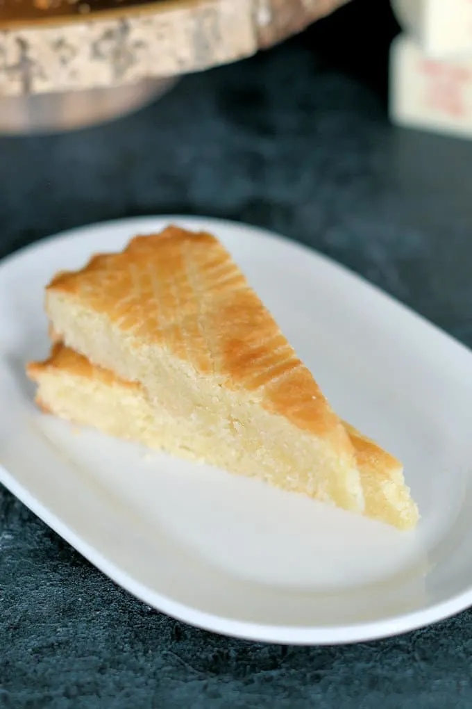 two slices of boterkoek, or dutch butter cake, on a plate