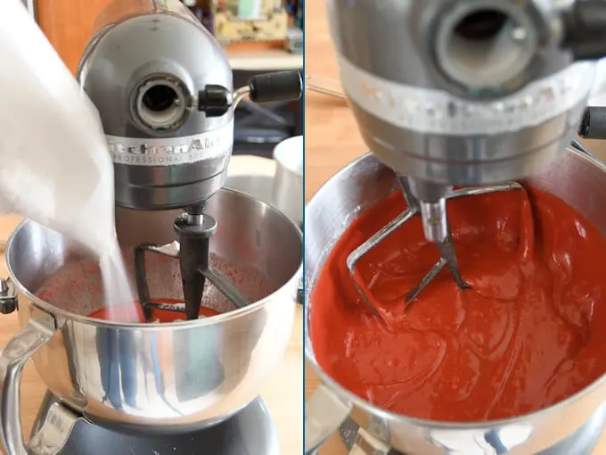 Adding dry ingredients to red velvet cake batter.