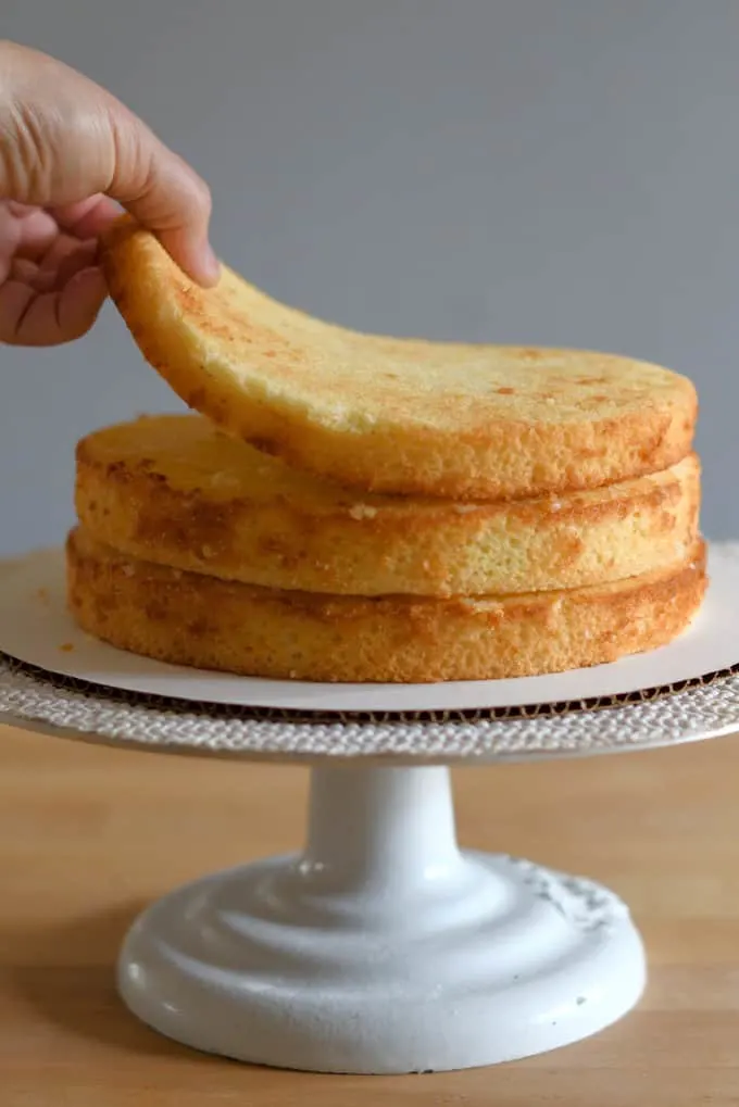 three vanilla buttermilk cake layers on a cake stand