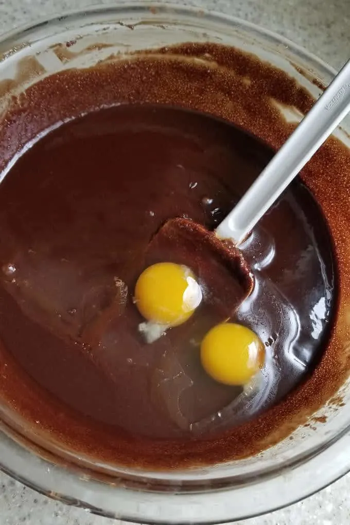 adding eggs to brownie batter