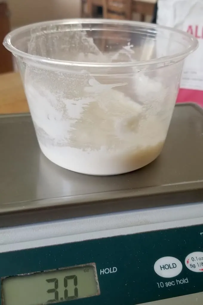 3 oz of sourdough starter in a small container