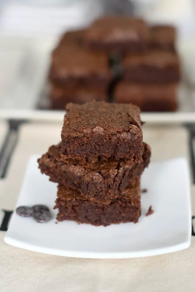 a stack of sourdough brownies on a white plate