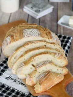 a sliced loaf of sourdough semolina bread on a cutting board