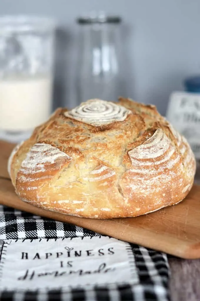 a loaf of sourdough semolina bread on a cutting board