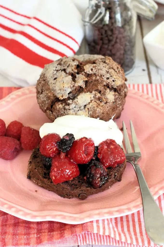 a raspberry and blackberry chocolate shortcake with cream on a plate