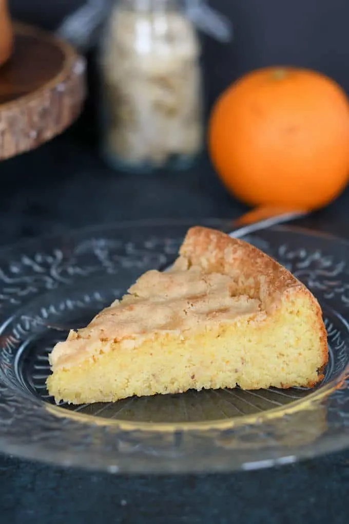 a slice of flourless almond cake on a plate