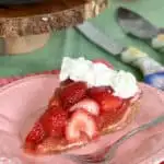 a slice of fresh strawberry pie on a pink plate