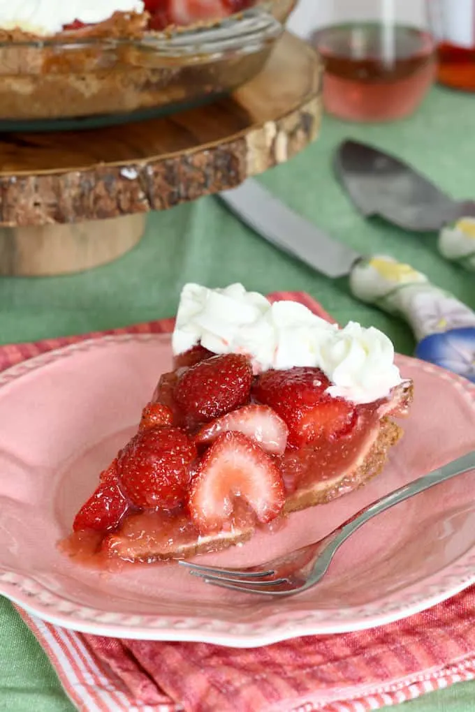 a slice of fresh strawberry pie on a pink plate