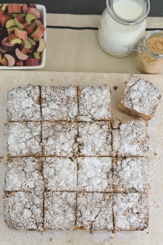 an overhead view of a crumb cake sprinkled with powdered sugar