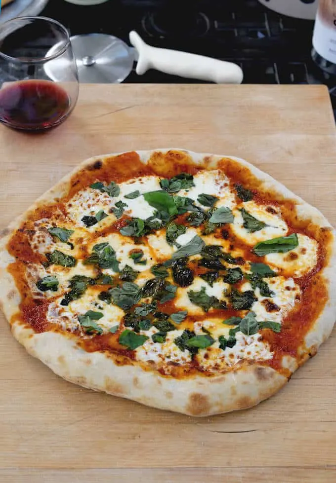 a pizza on a wooden cutting board