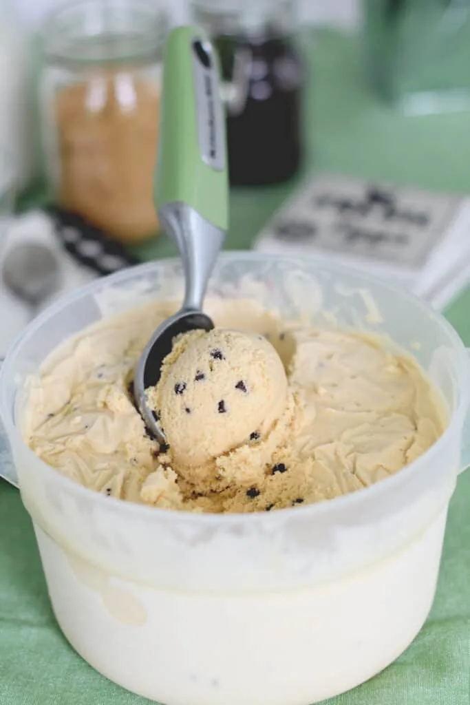 a bin of homemade cookie dough ice cream with a scoop