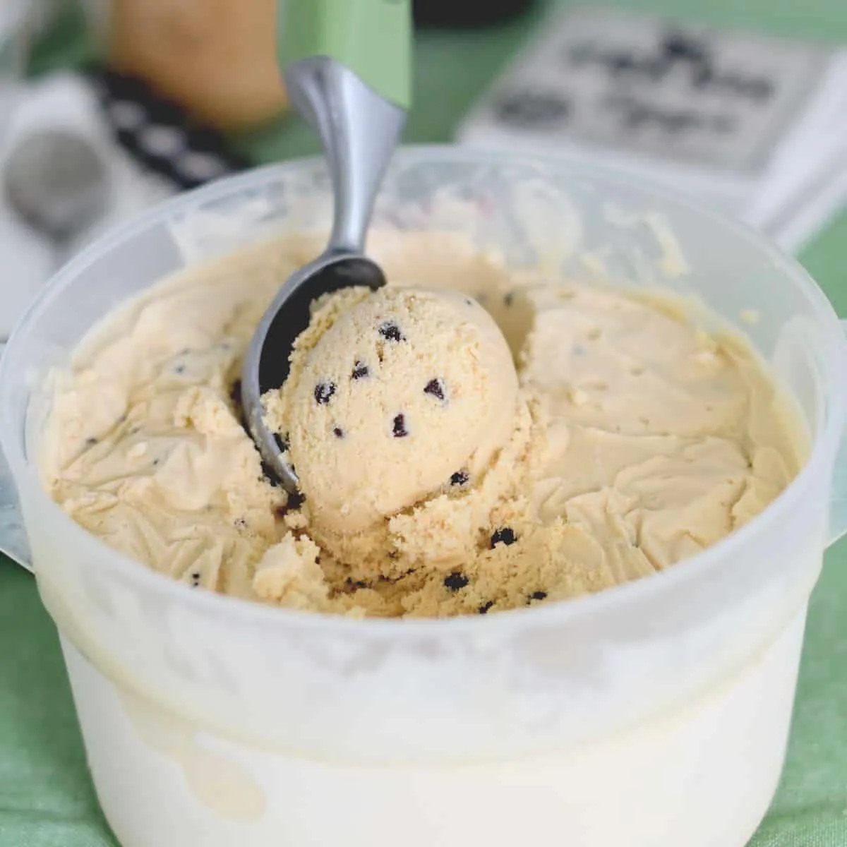a bin of homemade cookie dough ice cream with a scoop