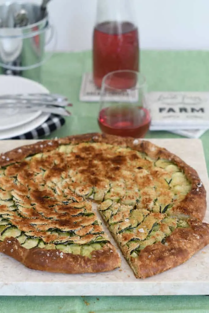 a zucchini galette baked in a whole wheat pie crust on a marble slab