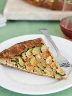 a slice of zucchini galette in a whole wheat pie crust on a plate