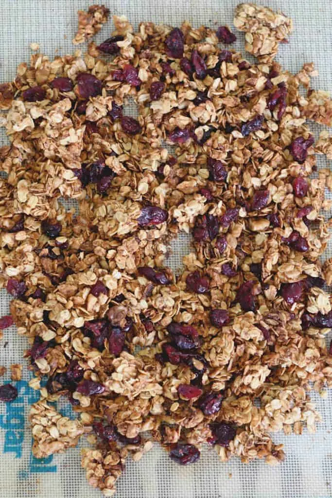 a tray of chunky granola with walnuts and cranberries