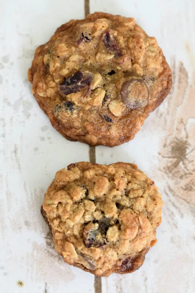 Two oatmeal cookies showing how the dough will spread less if the dough is chilled or frozen.