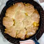 a pinterest image for fresh peach cobbler with text overlay