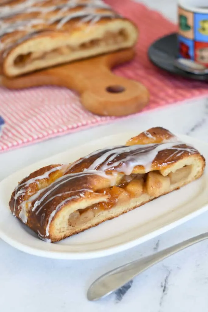 a slice of apple danish pastry on a white plate