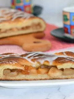 a slice of apple filled danish on a plate