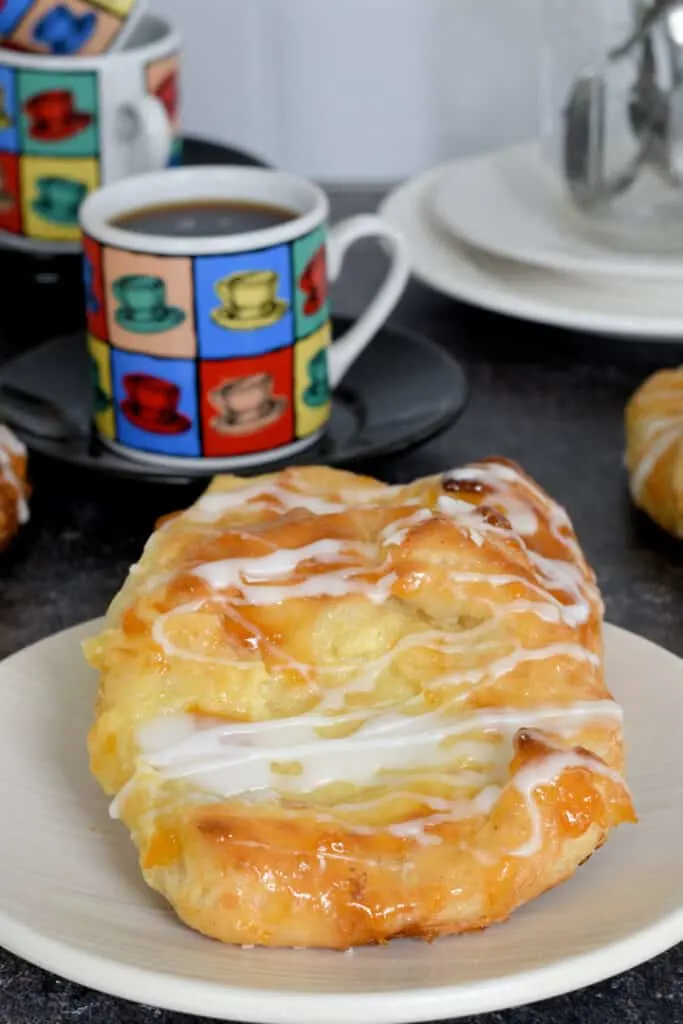 a glazed cheese danish on a plate