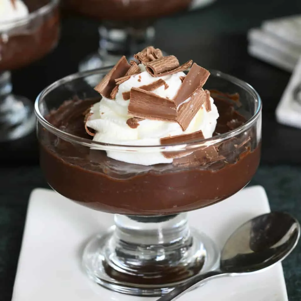 a glass dish filled with dark chocolate pudding