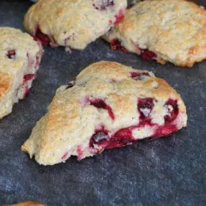 a cranberry orange scone on a dark surface