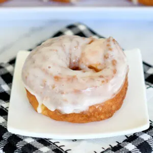 a french cruller donut on a white plate.