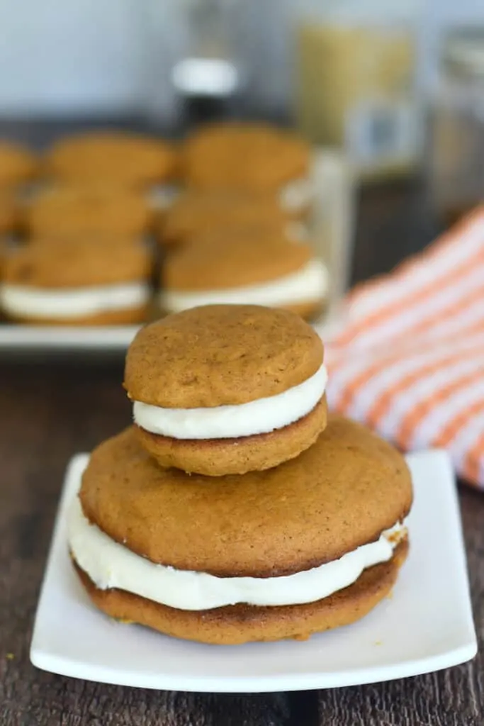 a large and a small pumpkin whoopie pie on a plate