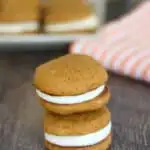 two pumpkin whoopie pies stacked on a table