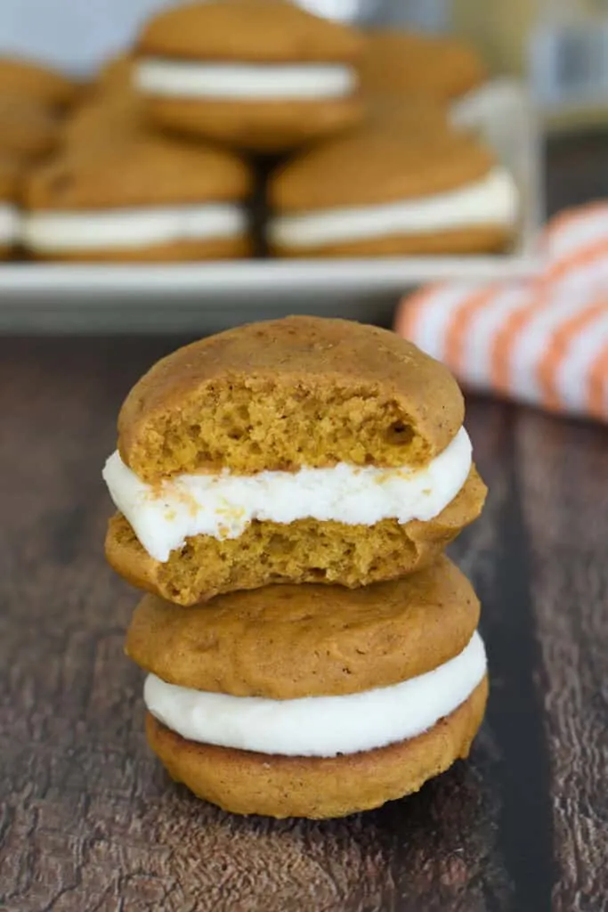 two small pumpkin whoopie pies on a table