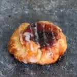 a sourdough danish pastry filled with jam is on a gray background