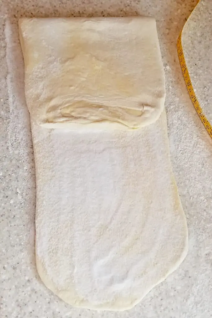 a photos showing how to layer sugar into sourdough kouign amann