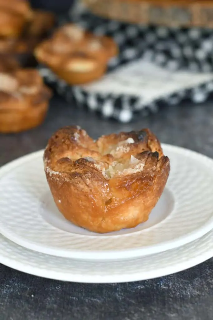 a sourdough Kouign Amann on a white plate