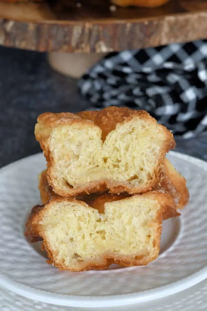 a split kouign amann on a plate showing the buttery layers