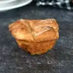 a kouign amann pastry on a black surface