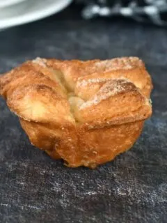 a kouign amann pastry on a black surface