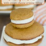 a large and a small pumpkin whoopie pie on a white plate.