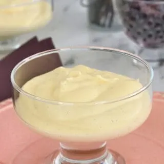 a dish of vanilla mousse on a pink plate