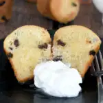 a baba au rhum on a plate with whipped cream