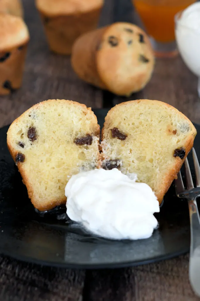 a baba au rhum on a plate with whipped cream