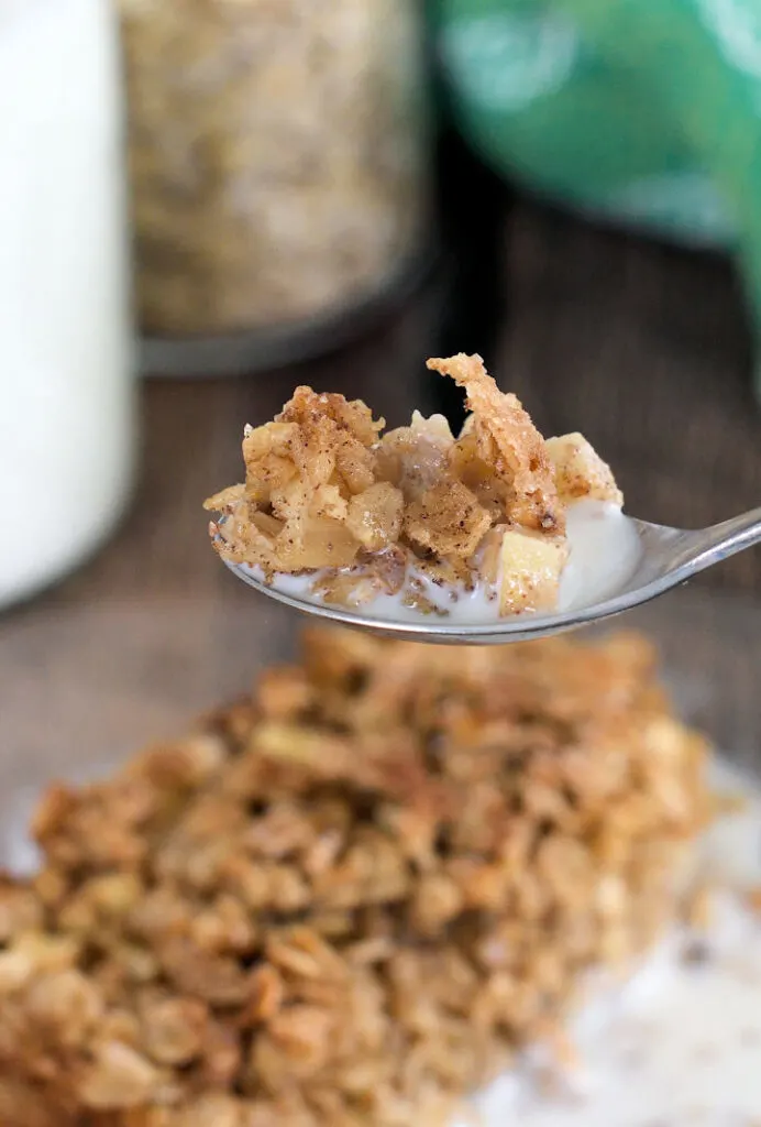 a spoonful of apple maple baked oatmeal with milk
